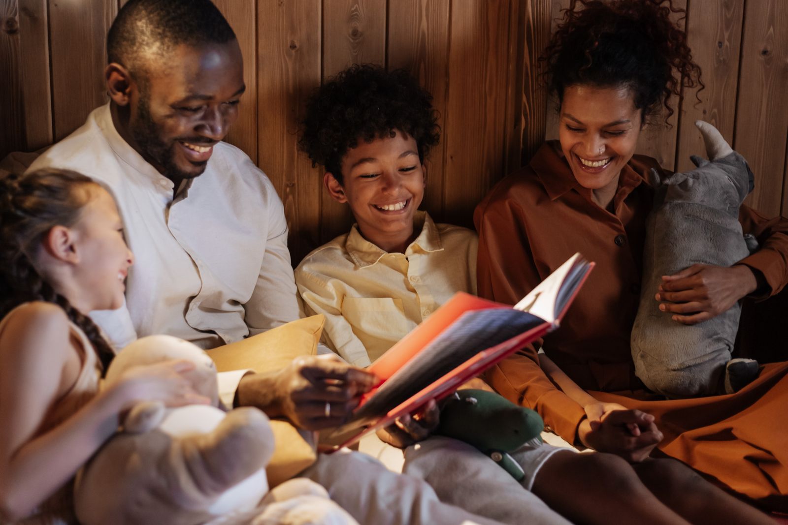 A family reading together in a warmly lit home
